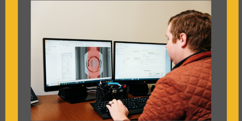 M&M International mechanical engineer working at desk with two monitors displaying plans